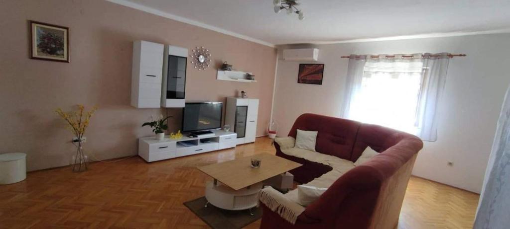 a living room with a couch and a table at Apartment Eva in Rovinjsko Selo