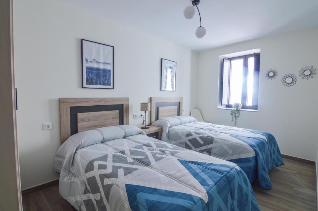Posteľ alebo postele v izbe v ubytovaní Apartamentos Turísticos Hornillo AT-CC-00681