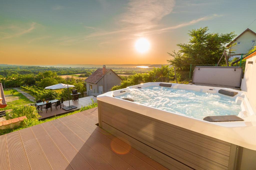 a hot tub on the deck of a house at Villa Kőhegy Zamárdi By BLTN in Zamárdi