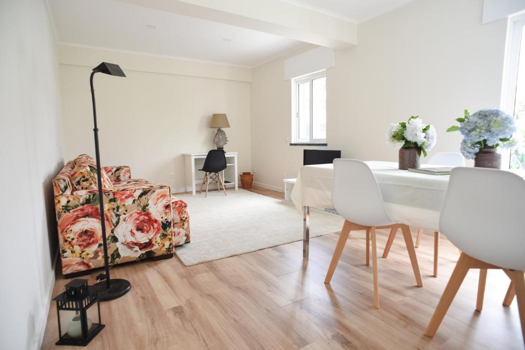 a living room with a table and a chair at Nia Azorean Apartments in Horta