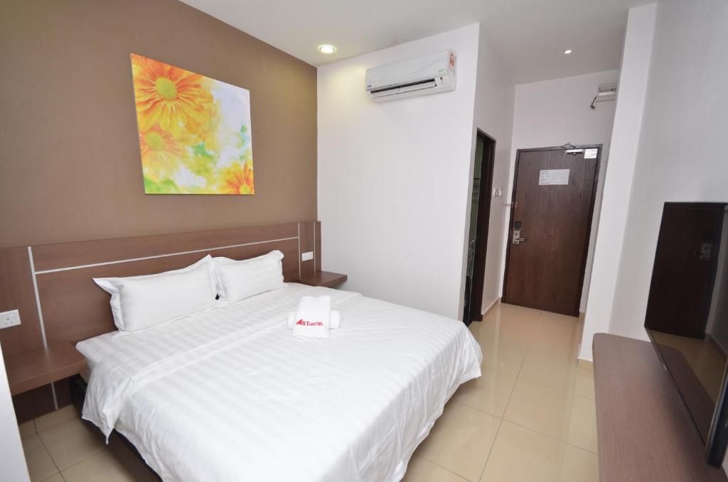 Letto o letti in una camera di AST Hotel