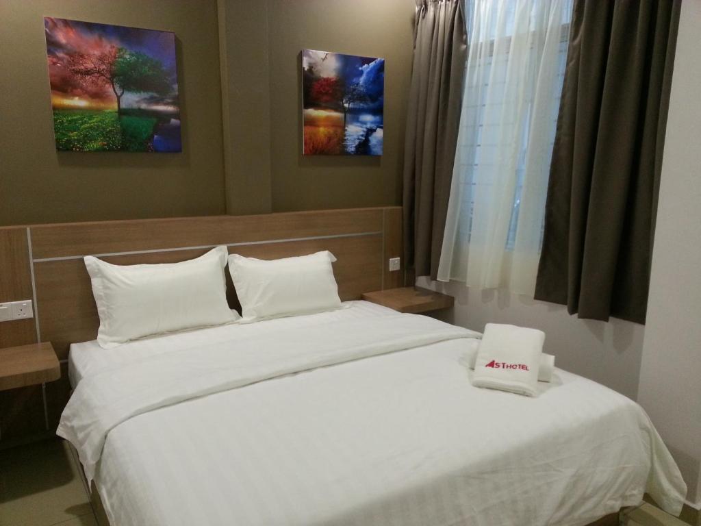 Letto o letti in una camera di AST Hotel