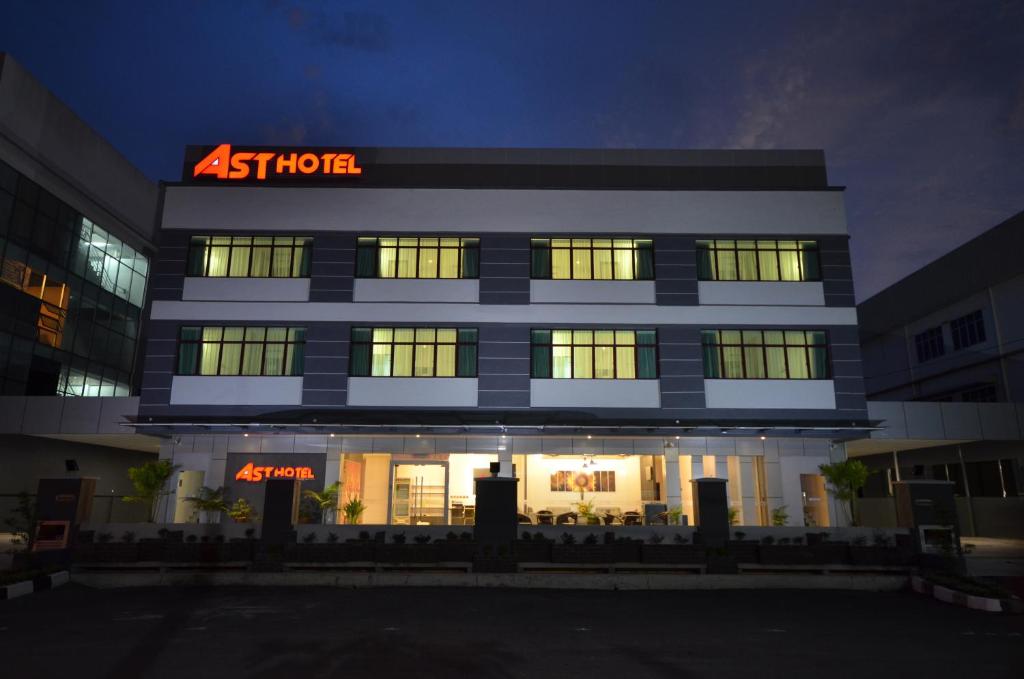 un edificio illuminato con un cartello di atens di AST Hotel a Alor Setar