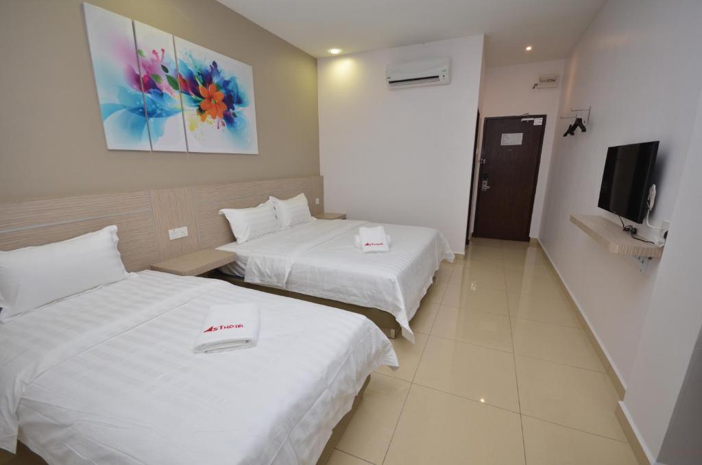 Letto o letti in una camera di AST Hotel