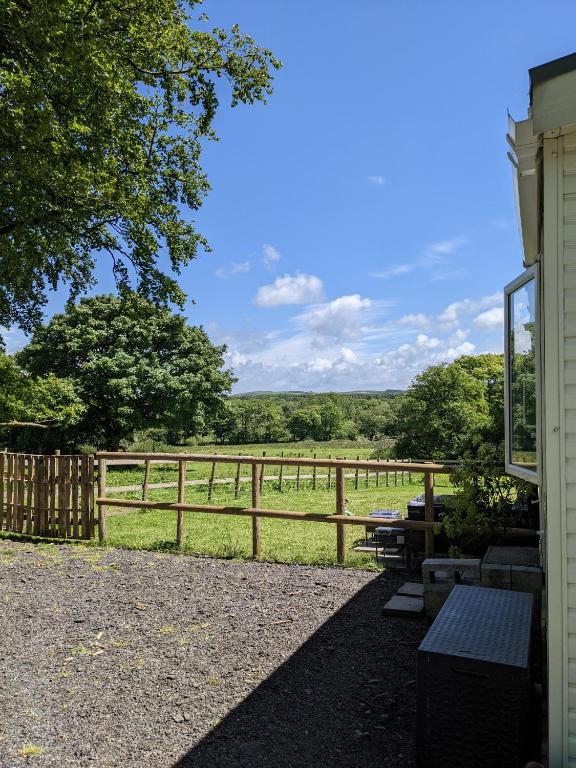 a fence with a view of a field at Neigh's Gate in Cross Inn