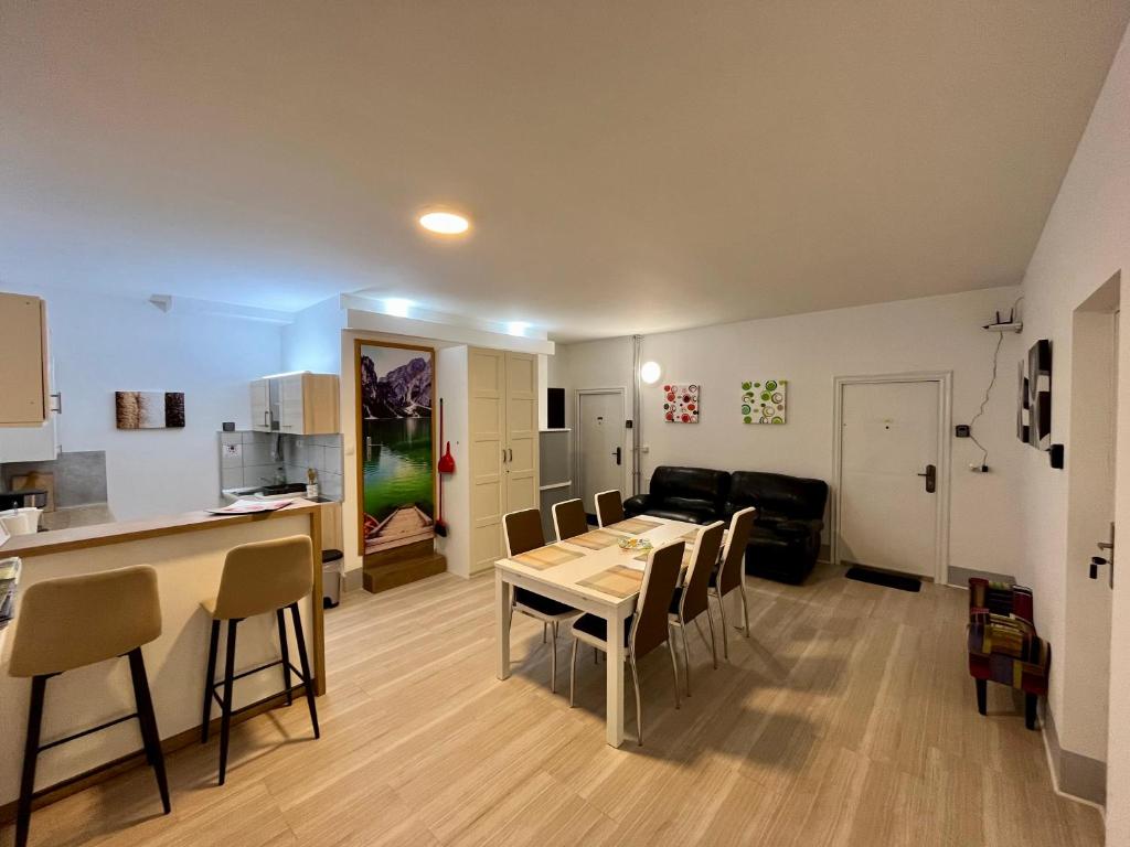 a kitchen and a dining room with a table and chairs at Guest House Černe in Vrhnika