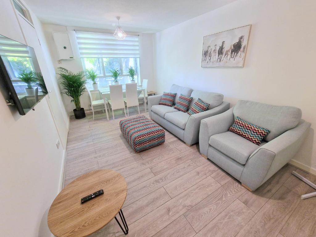 a living room with a couch and a table at Flat in Battersea, 5 minutes from Clapham Junction Station in London
