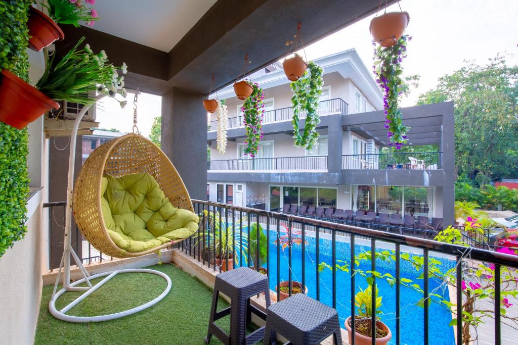 a balcony with a swing and a swimming pool at 4bhk Stunning Apartment with Pool 2bhkX2 in Old Goa