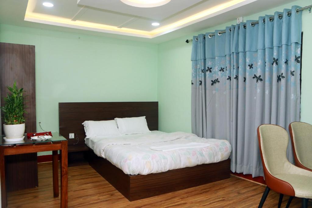 a bedroom with a bed and a table and chairs at Kathway Hostel & Homestay in Kathmandu