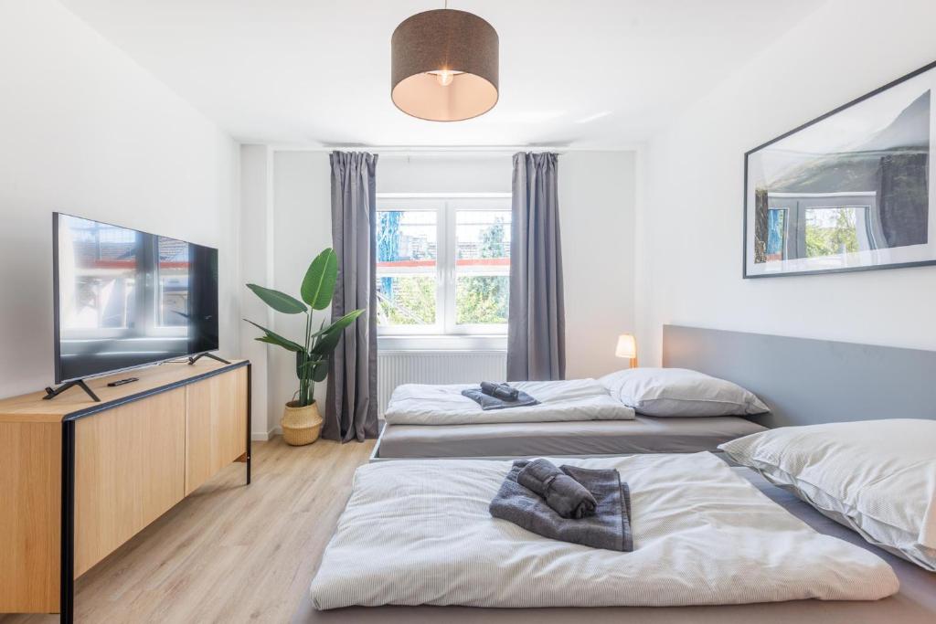 Postel nebo postele na pokoji v ubytování Glück Auf Appartements Schleiermacherstraße Duisburg