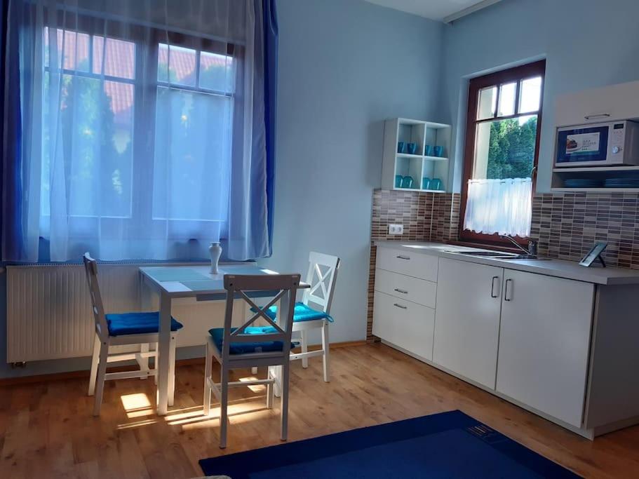 a kitchen with a table and chairs in a room at House w little tropical garden in Budapest