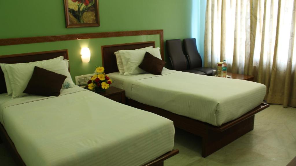Postel nebo postele na pokoji v ubytování Hotel Chennai Gate