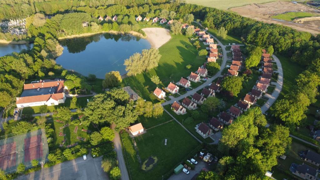 an aerial view of a village with houses and a lake at Vakantiepark 't Broeckhuys in Ewijk