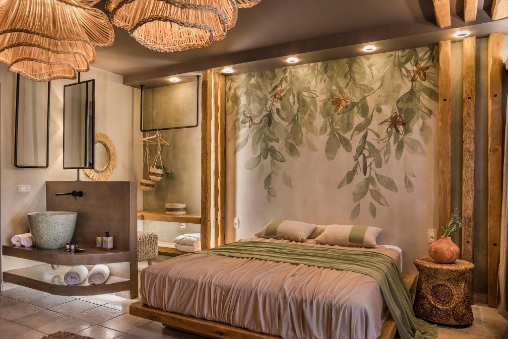 a bedroom with a bed with a large painting on the wall at Avithos Resort Hotel in Svoronata
