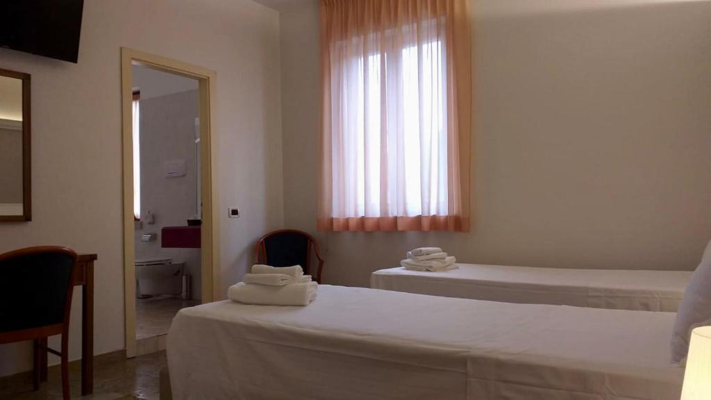 Posteľ alebo postele v izbe v ubytovaní Hotel Elefante