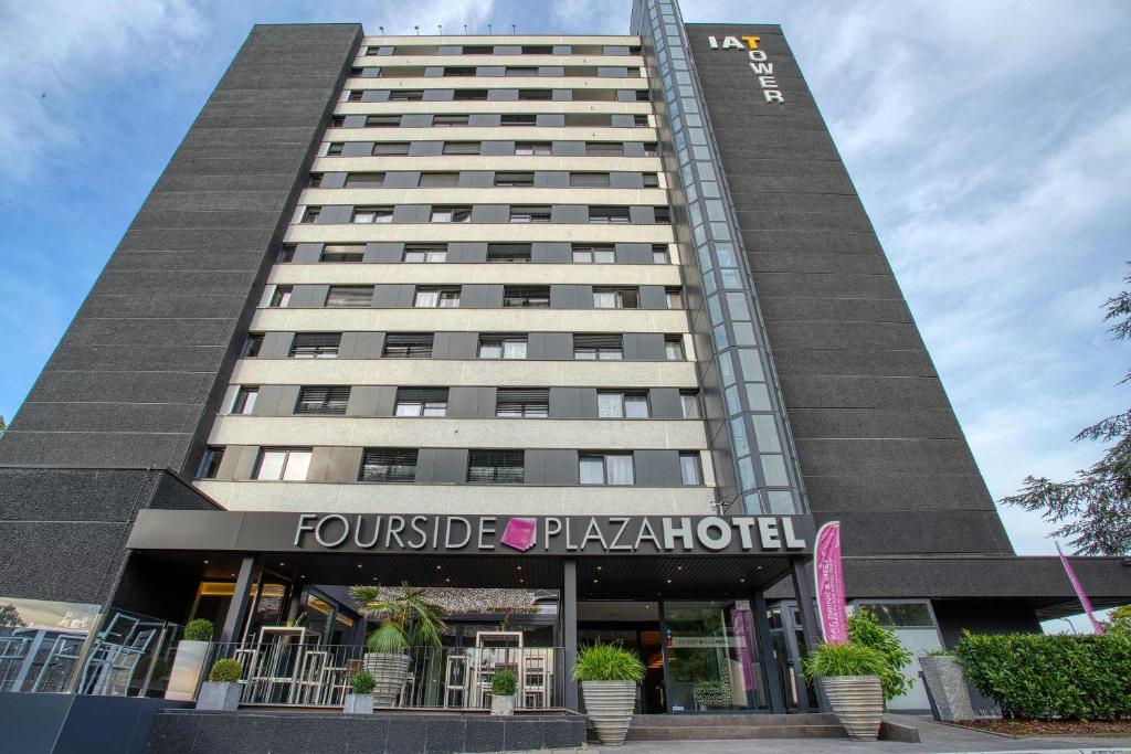 a building with the front of a hotel at FourSide Hotel Trier in Trier