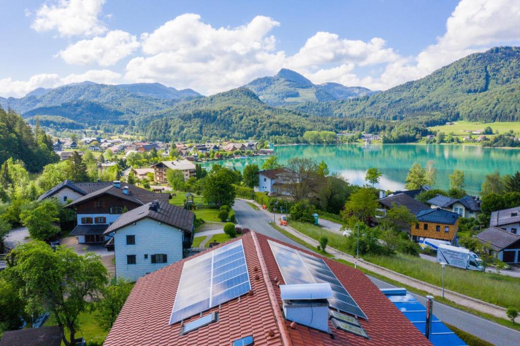 a view of a town with a lake and mountains at Haus Bergblick in Fuschl am See