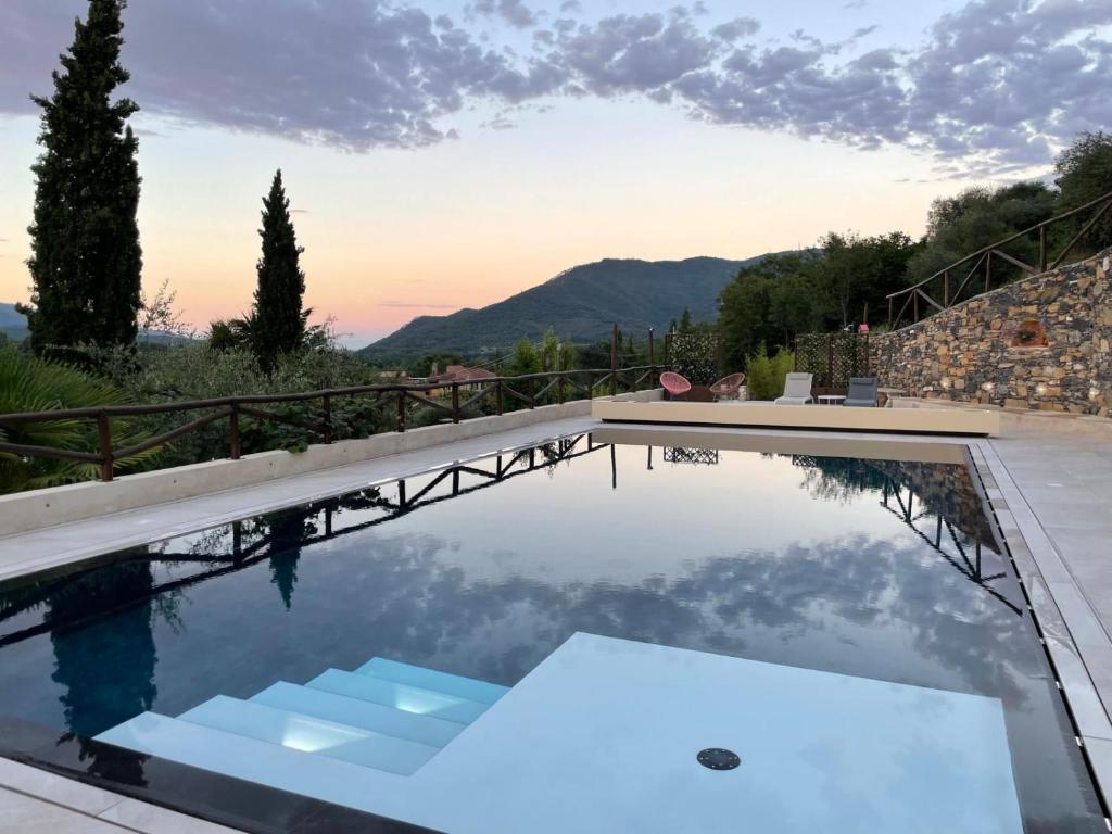 a swimming pool with a view of the mountains at Borgata Cantone Country House B&B in Garlenda