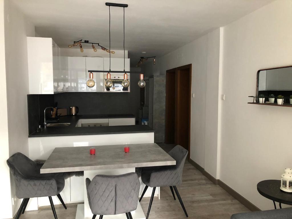 a kitchen with a table and chairs in a room at Ski and Lake View Apartment in Zell am See
