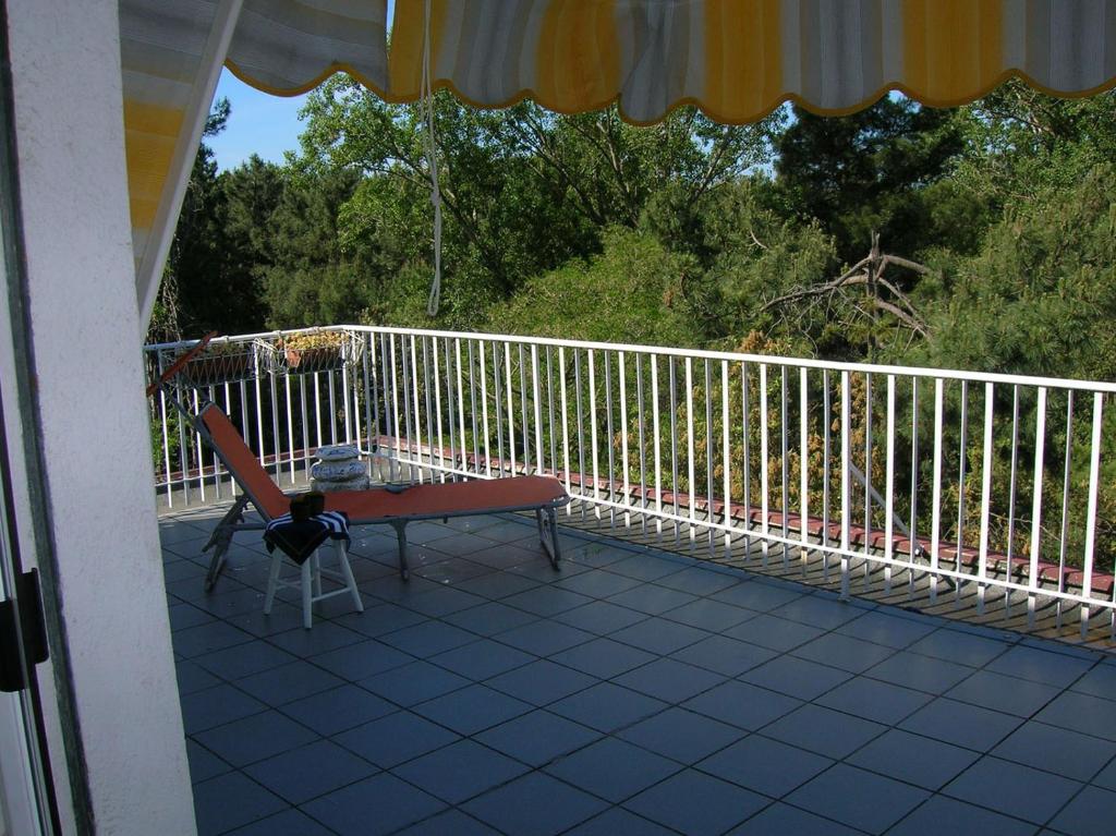 a porch with a bench and a chair on it at Atticogrado in Lido