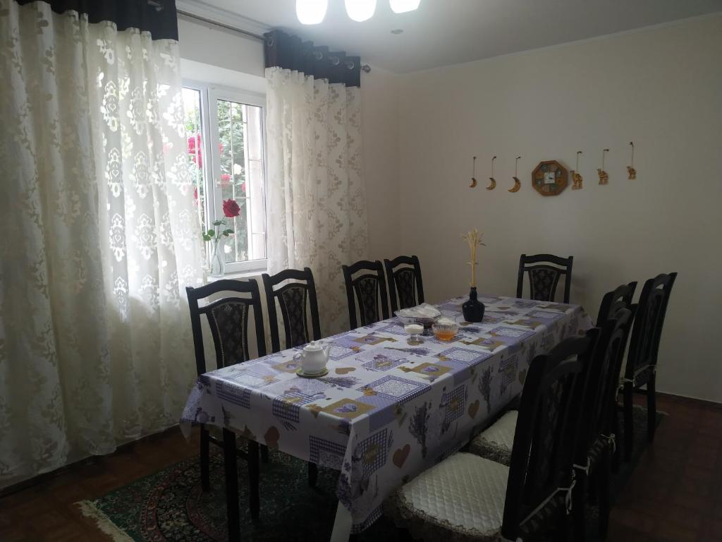 a dining room with a table and chairs and a window at Guest House Regina in Bulan Sogottuu