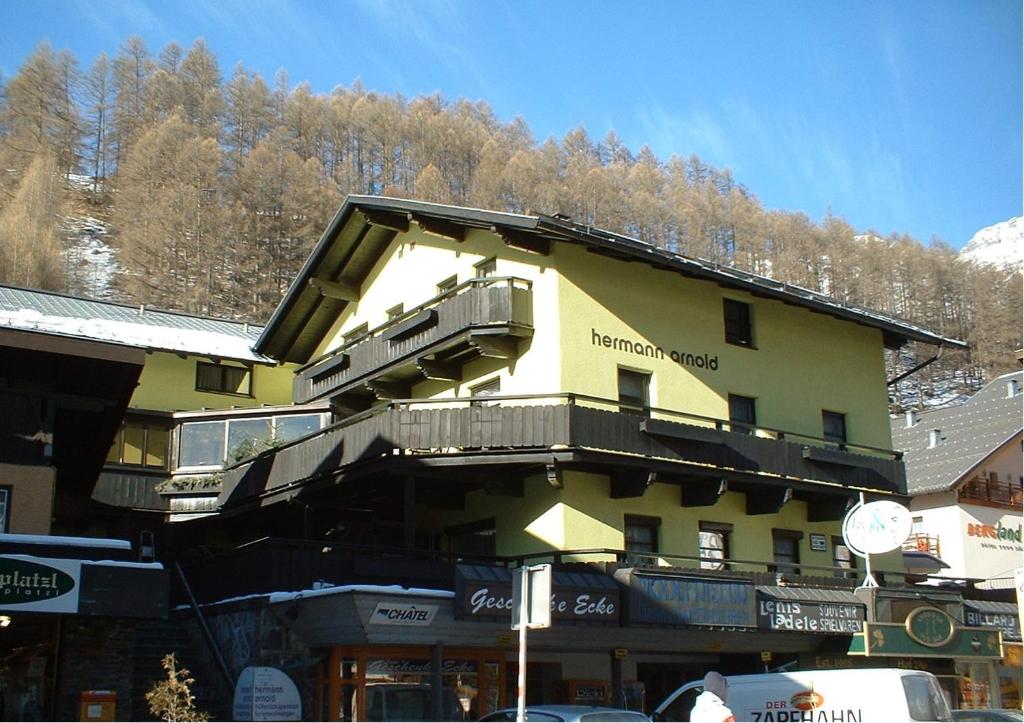 a yellow building with balconies on the side of it at Haus Arnold by Châtel Reizen in Sölden