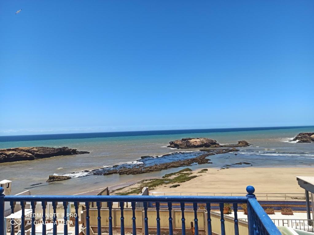 a view of a beach with rocks in the water at Riad La Rose Des Vents in Essaouira