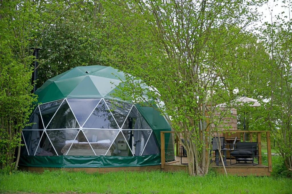 a green dome tent in a yard with a tree at Finest Retreats - Hever Luxury Dome 