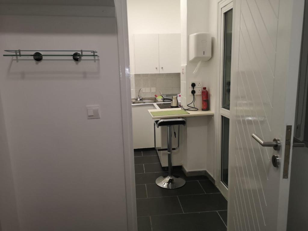 a white kitchen with a sink and a counter at Kalidonia “PANORAMA” STUDIO APARTMENT in İncirli
