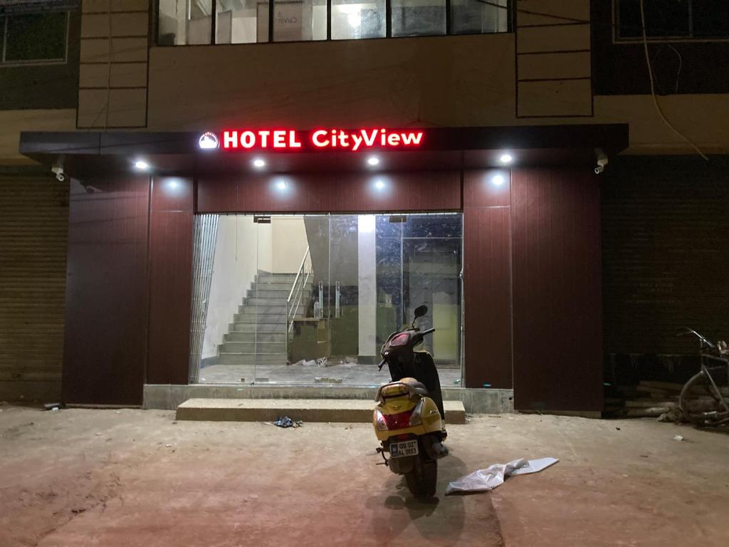 a motorcycle parked in front of a hotel city view at Hotel City View in Bhubaneshwar