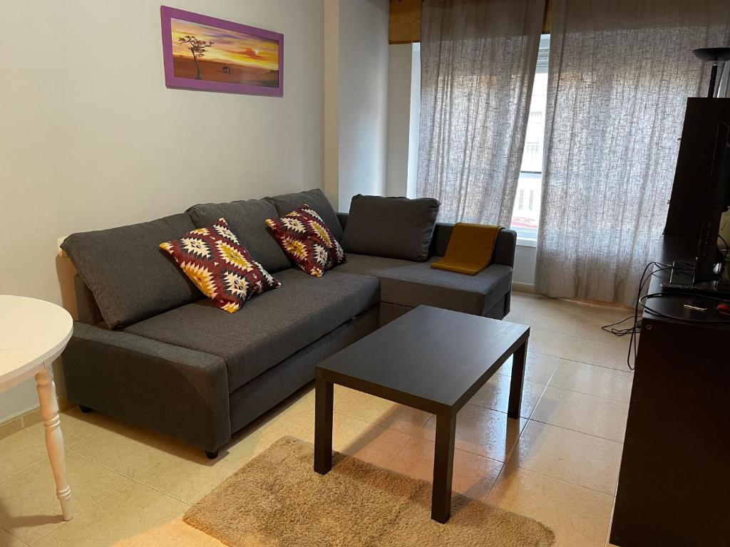 a living room with a couch and a table at Apartamentos Trevias in Trevías