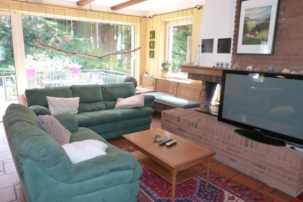 a living room with a couch and a flat screen tv at Schreiner in Daun