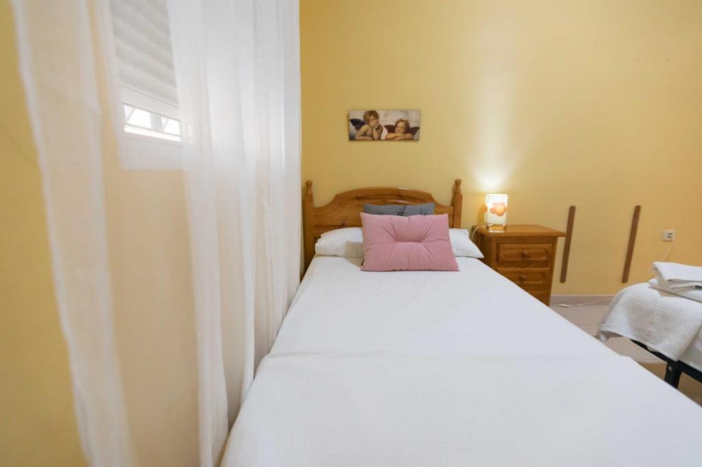 מיטה או מיטות בחדר ב-Apartamento Alcazaba