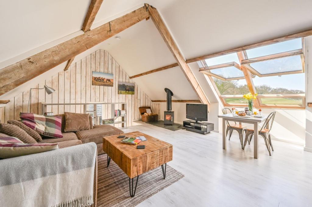 a living room with a couch and a table at The Round House in Trentishoe