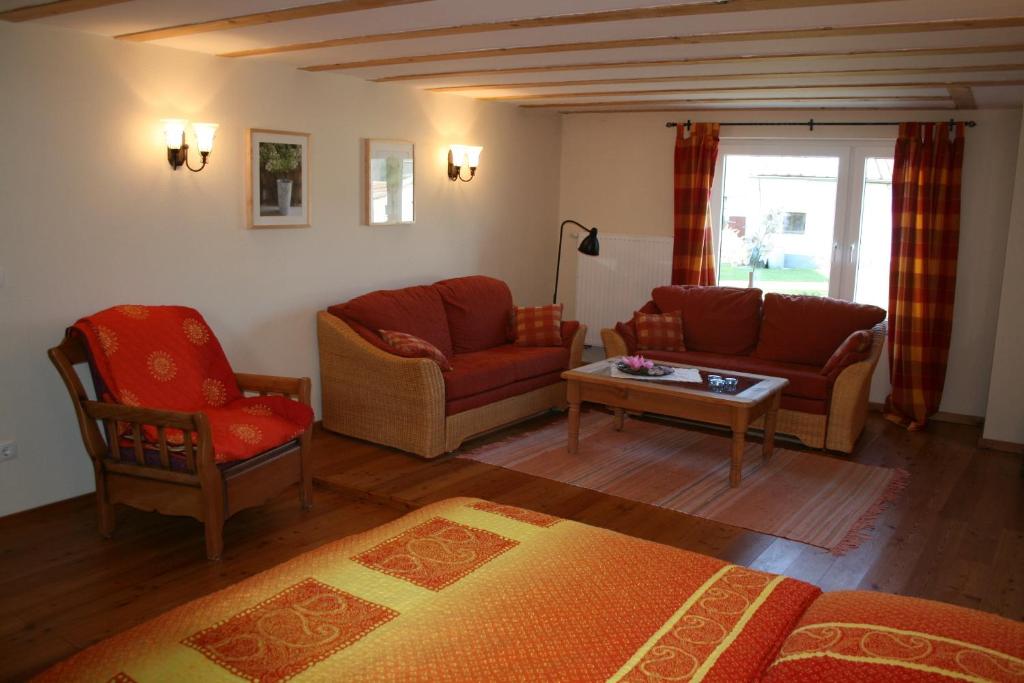 a living room with two couches and a table at Ferienwohnung Schlössershof in Borler
