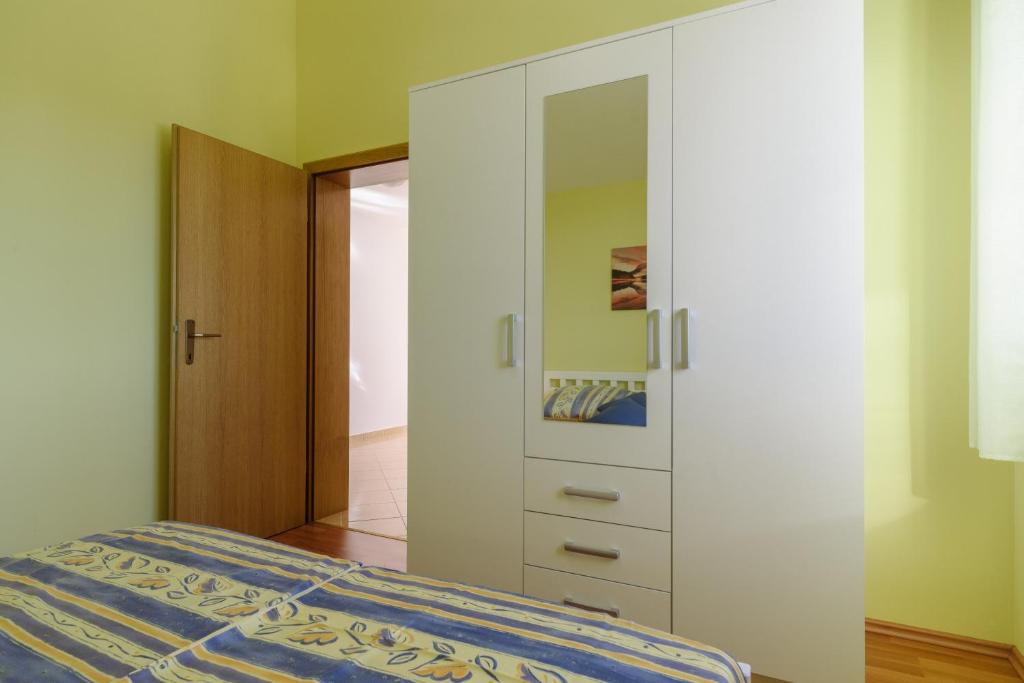 Posteľ alebo postele v izbe v ubytovaní Apartmani Emil