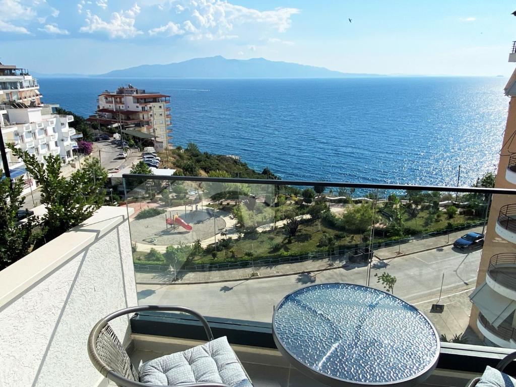 a balcony with a table and a view of the ocean at Sea view Apartment Elite2 in Sarandë