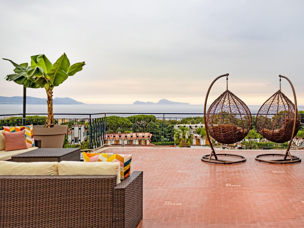 a patio with two hanging baskets on a roof at Panorama Love to Stay in Ercolano