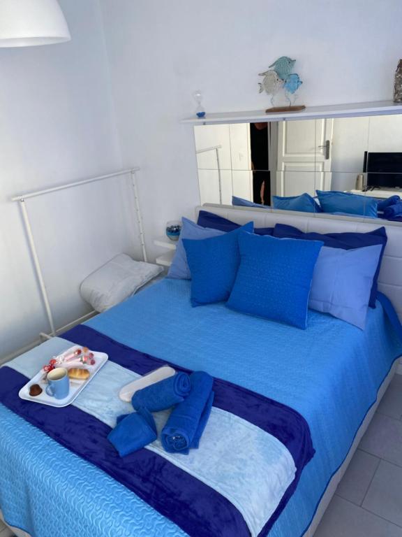 a blue bed with a tray of food on it at Casa Yurena in Playa Honda