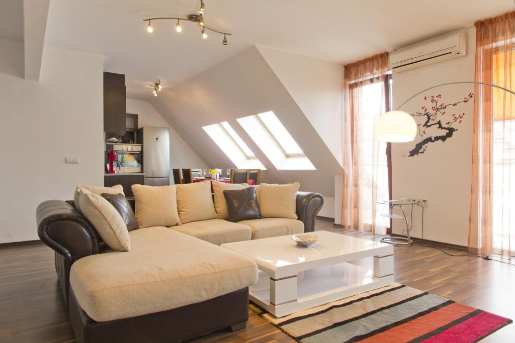 a living room with a couch and a coffee table at Vitosha Downtown Apartments in Sofia