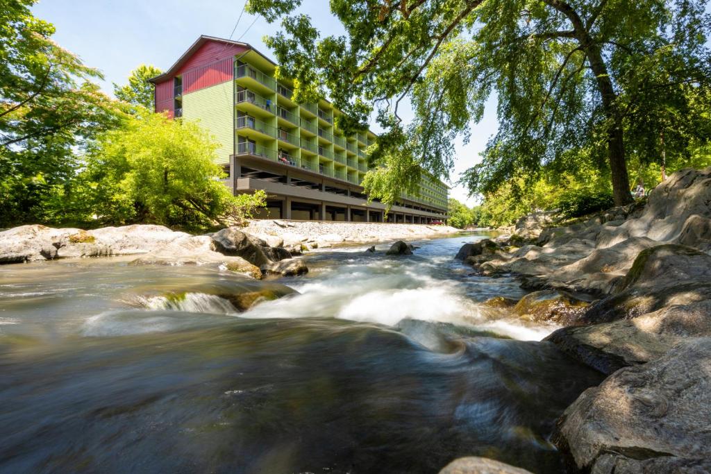 a river in front of a building at Creekstone Inn in Pigeon Forge