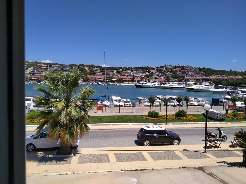a view of a parking lot with a car and a harbor at VENÜS PARK APART SUİTES in Cesme