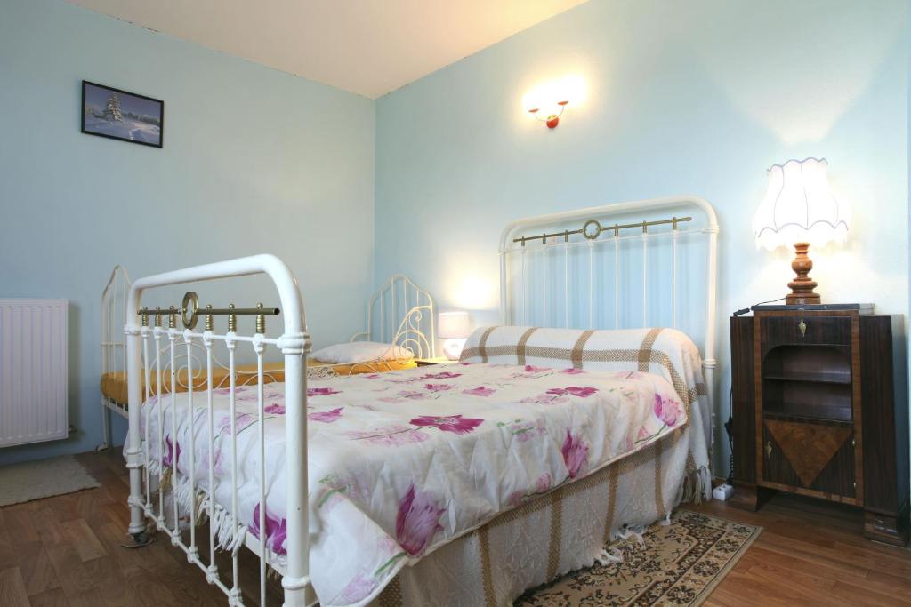 a bedroom with a white bed and a dresser at Les Planettes in Saint-Sernin-lès-Lavaur