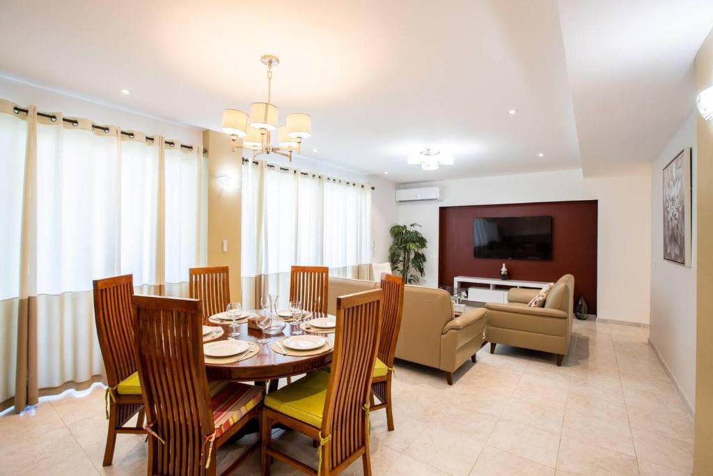 a dining room and living room with a table and chairs at Garden View Condo in Maho in Maho Reef