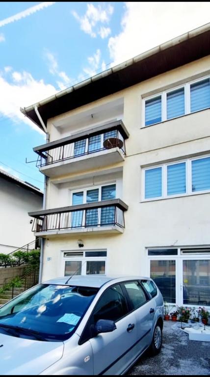 a white car parked in front of a building at Urban Home Visoko in Visoko
