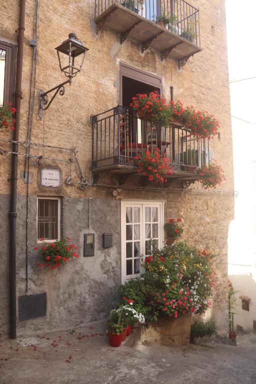 a building with flower boxes and balconies on it at Marianna in Isnello