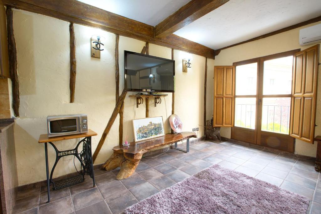 TV a/nebo společenská místnost v ubytování Cuencaloft Jardines