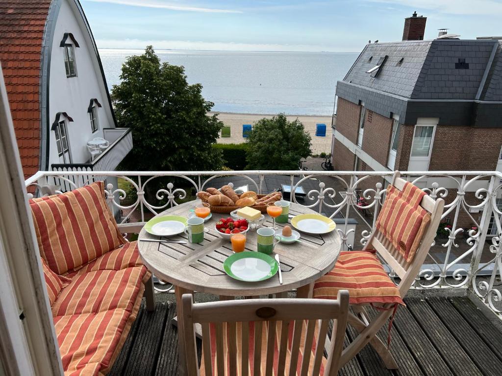 einen Tisch mit einem Teller Essen auf dem Balkon in der Unterkunft Sandwallkoje in Wyk auf Föhr