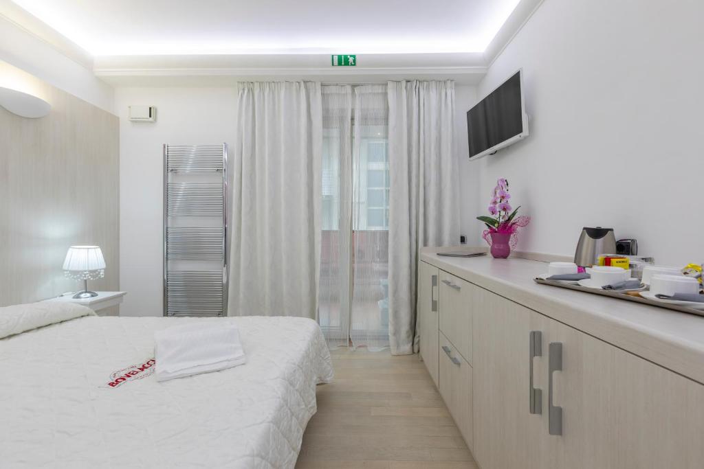 Postel nebo postele na pokoji v ubytování Boutique Hotel Paradiso Bovelacci
