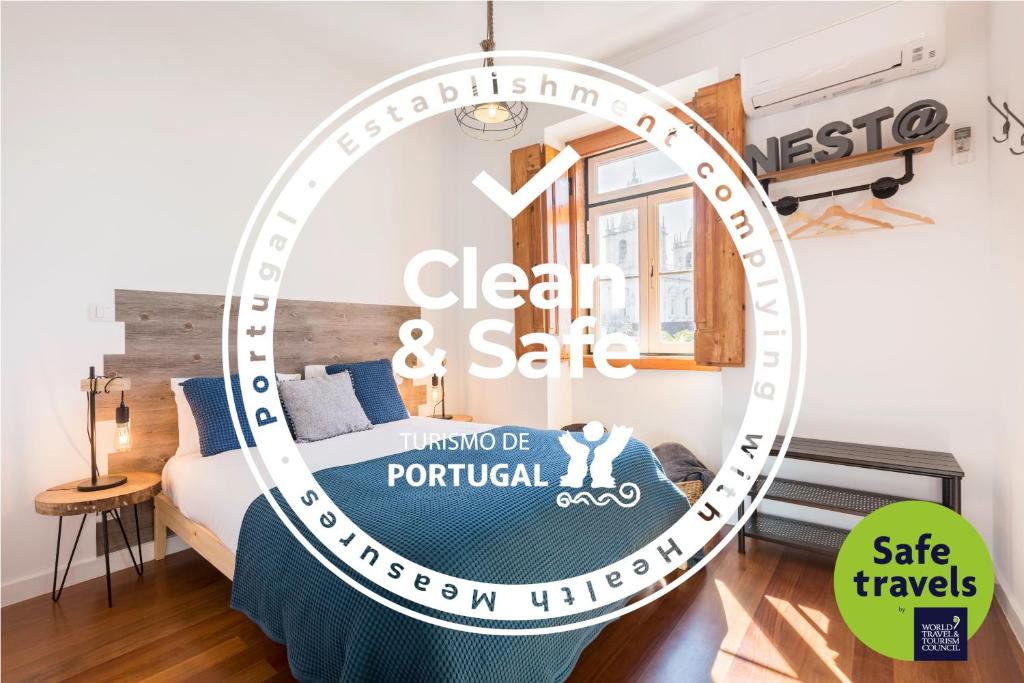 a bedroom with a bed with a sign that reads clean and safe at Stunning and Spacious Lofts just by Graça and Alfama in Lisbon